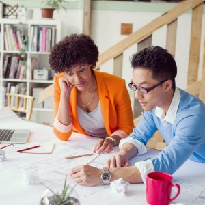 Two desingers working on a project together in office