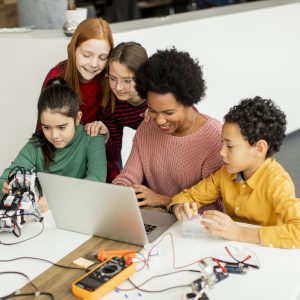 happy kids with their African American female science teacher
